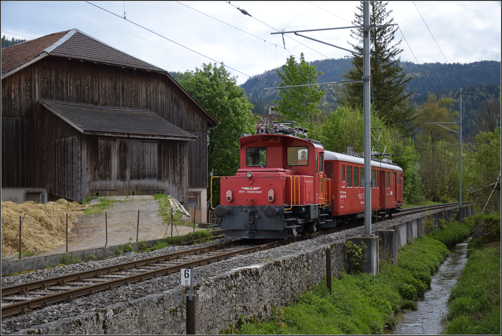 Der Funkelnde.

Rangiertraktor Tem II 292 wird von L'Etincellante ABDe 2/4 101 mitgeschleppt, denn er wird f�r den letzten Abschnitt nach St-Sulpice noch gebraucht. M�tiers, Mai 2024.